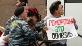Russian police arrest a gay-rights activist holding a poster reading "Homophobia is a disease" during a banned gay-pride rally in St. Petersburg in June.