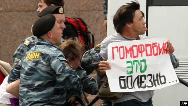 Russian police arrest a gay-rights activist holding a poster reading "Homophobia is a disease" during a banned gay-pride rally in St. Petersburg in June.