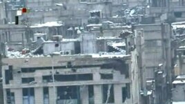 A screen grab from Syrian television shows damaged buildings covered in snow in the besieged Baba Amro district of Homs, purportedly on March 2.