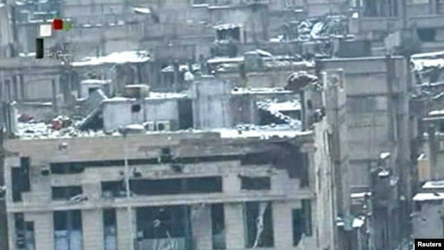 A screen grab from Syrian television shows damaged buildings covered in snow in the besieged Baba Amro district of Homs, purportedly on March 2.