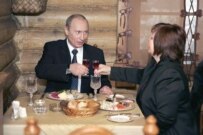 Vladimir Putin, dining with his wife after voting on December 2, will head a party with enough seats to change the constitution (ITAR-TASS)