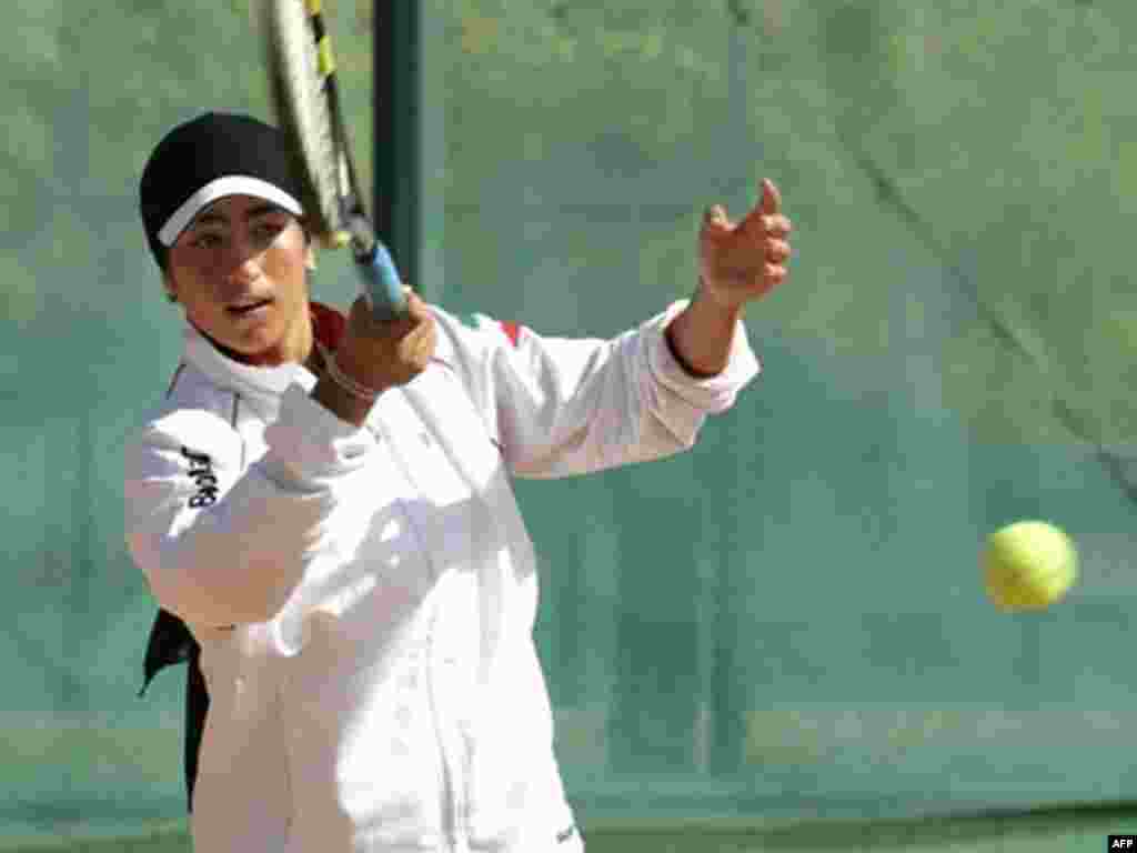 Tennis player Arghavan Rezaei, who plays for both Iran and France, trains before the tennis finals at the Fourth Islamic Women's Games at Tehran's Azadi Stadium in September 2005.