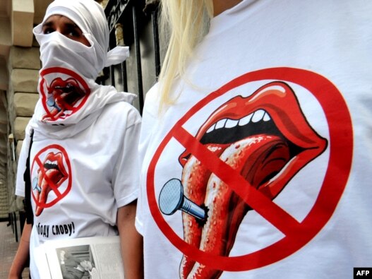 Young activists of the 'Freedom of the Press' civil initiative wear T-shirts with their logo as they give out leaflets in front of Ukraine's Secret Service building in Kyiv in June 2010. Freedom House found a 'significant decline' in press freedom in Ukra