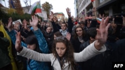 Students held up their hands to protest what they regarded as police violence during an antigovernment protest in downtown Sofia on November 13.