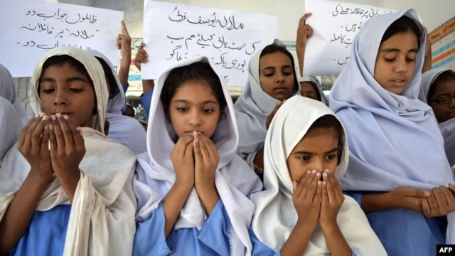 Schoolgirls pray for the recovery of gunshot victim Malala Yousafzai in Multan, in central Pakistan.