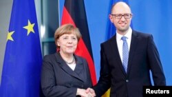 German Chancellor Angela Merkel (left) shakes hand with Ukrainian Prime Minister Arseniy Yatsenyuk after talks at the Chancellery in Berlin on April 1.