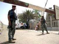 Iraqi police outside the Finance Ministry building today (AFP)