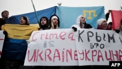 Demonstrators hold placards reading "Crimea is Ukraine" during a rally on Independence Square in central Kyiv in March.