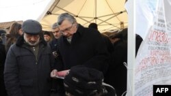 Georgian opposition supporters collect signatures for a petition asking for the resignation of President Mikheil Saakashvili near his office in central Tbilisi on January 4.