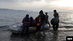 Afghan migrants disembark on a beach on the Greek island of Kos after crossing the strait from Turkey, in May.