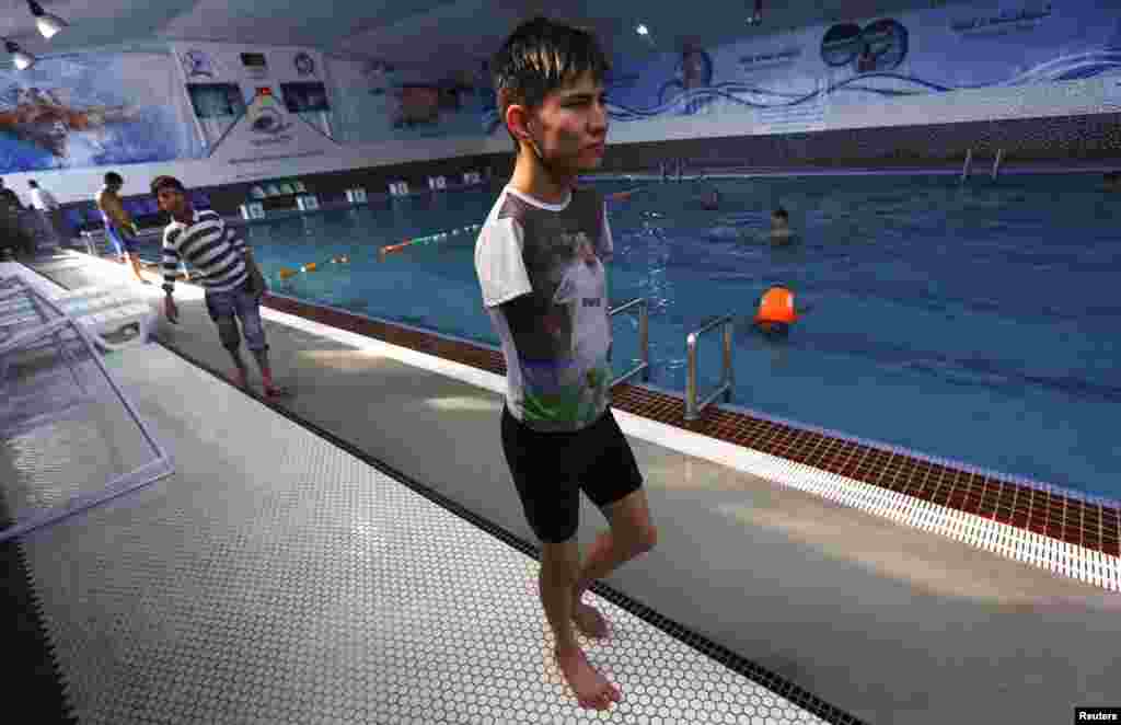 Abbas Karimi stands beside a public swimming pool in Kabul.