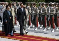 Presidents Khatami (left) and al-Assad review the honor guard in Tehran