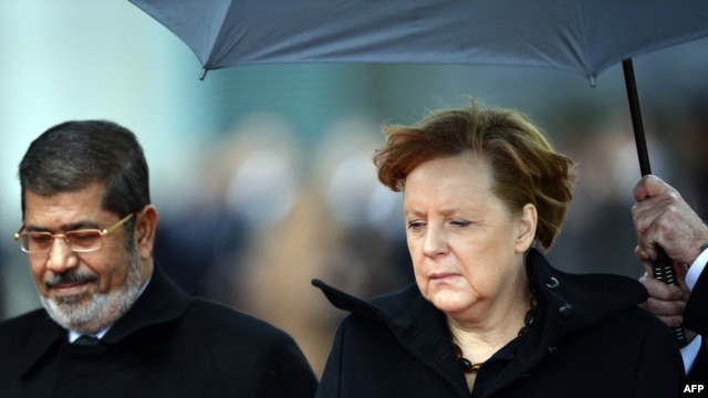 German Chancellor Angela Merkel (right) with Egyptian President Muhammad Morsiin Berlin on January 30.