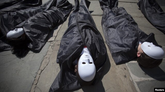 Campaigners from the Control Arms coalition lie in fake body bags at a demonstration in front of the UN building in New York earlier this month.