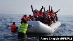 Syrian student Daoud Daoud (center, arms raised) was one of 4,000 new arrivals to the island of Lesbos during the last weekend in February.