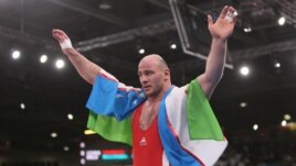 Uzbekistan's Artur Taymazov celebrating Olympic victory.