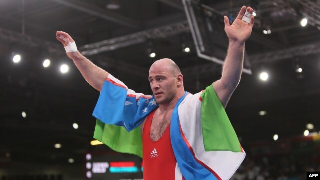 Uzbekistan's Artur Taymazov celebrating Olympic victory.