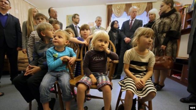 Ukrainian children from Makeevka, eastern Ukraine, watch TV in a refugee center in Kyiv.