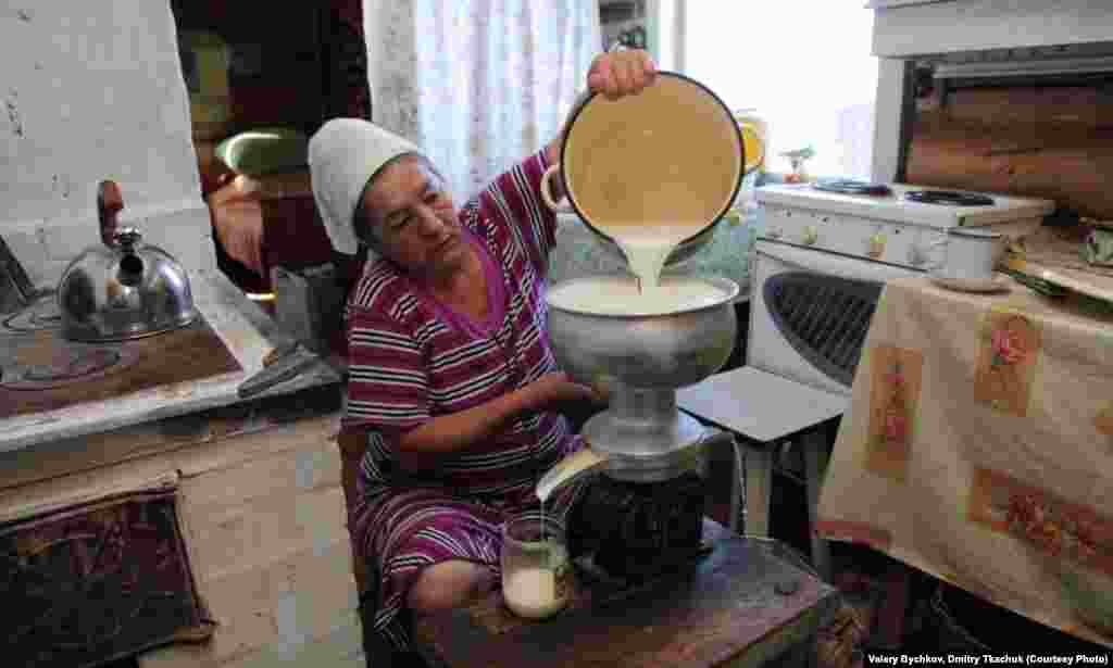 A woman makes cream in her kitchen.