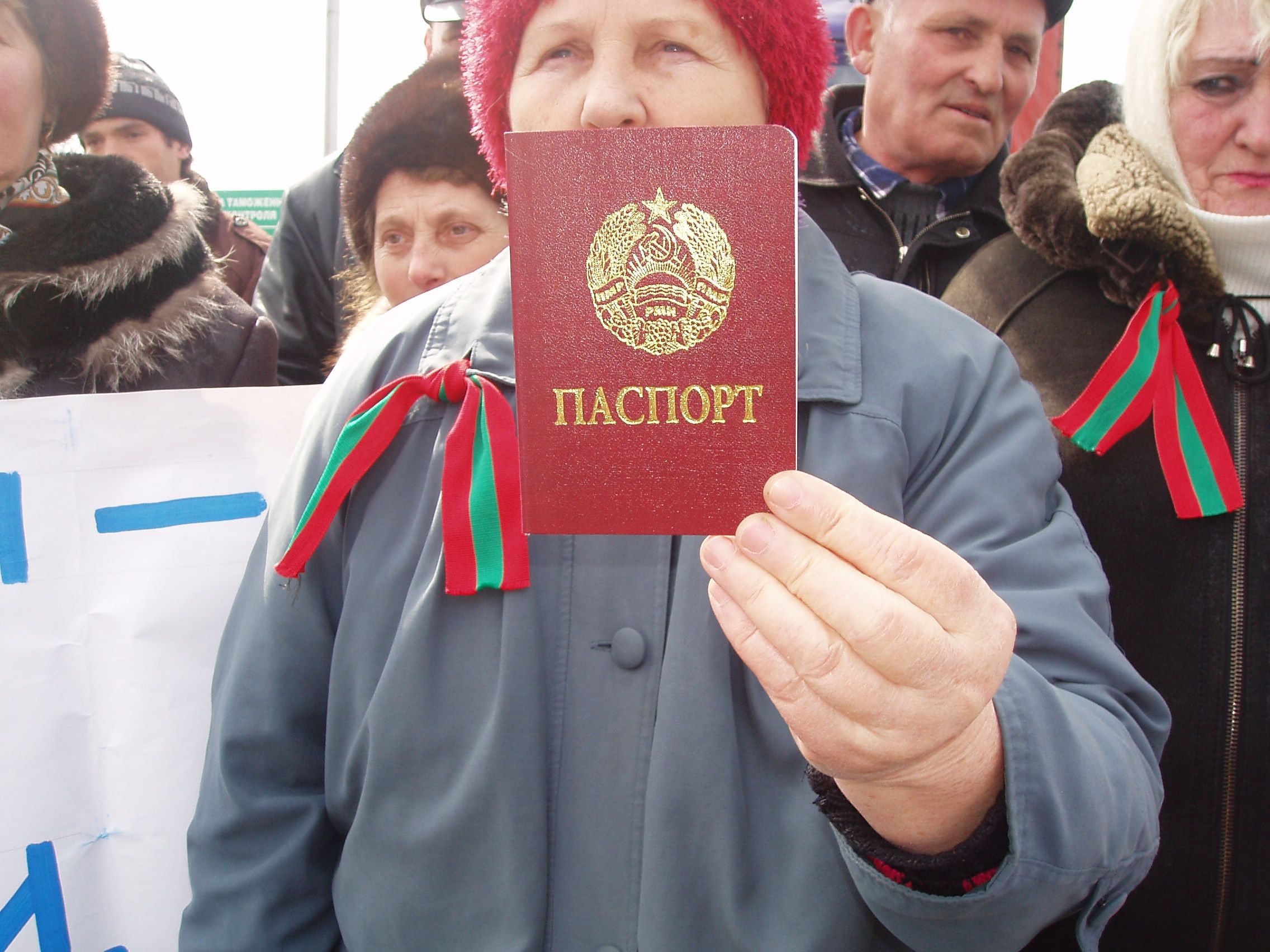 A Transdniestrian woman shows her passport at a demonstration against the new customs regime at the Ukrainian border on March 20 (RFE/RL)