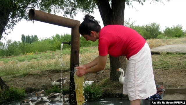 A woman washes clothes in Celebiler.