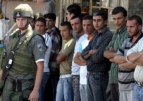 Palestinians line up at a checkpoint in Hebron in July (epa)