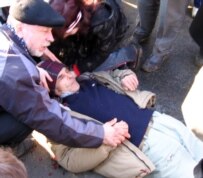 A demonstrator on the ground during the March 25 unrest (RFE/RL)