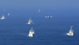 Chinese ocean surveillance, fishery patrol ships, and a Japan Coast Guard patrol ship (right) all sail about 15 kilometers west of the disputed islands, in the East China Sea, on September 18.