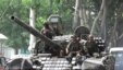 Georgia -- Georgian soldiers sit on a tank traveling through Gori, 11Aug2008