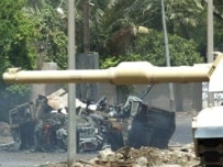 A U.S. military vehicle destroyed in one of Baghdad's latest roadside bomb attacks, July 11 (AFP)
