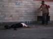 A wounded man lies on the ground after the militia fired into the crowd.