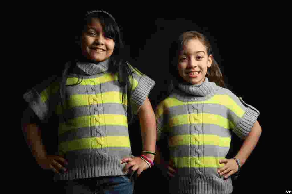Third-grader Nolelis Almanzar, 9, and her second-grade sister Noreamy Almanzar, 7, come from the Dominican Republic. Their father, Norberto Almanzar, is a taxi driver.