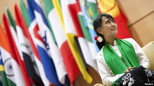 Aung San Suu Kyi waits before she delivers a speech during the last day of the 101st session of the International Labor Conference of the ILO in Geneva on June 14.
