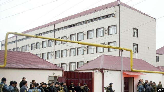 Special forces stand outside the parliament building in Grozny. At least six people were killed in the militant attack.