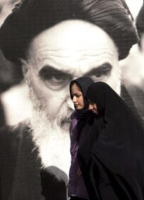 Two women pass an image of the late Ayatollah Khomeini, leader of the Islamic Revolution in Iran (file photo) (epa)