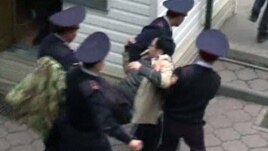 Полицей Ермек Нарымбаевты "Алға" партиясының кеңсесінен әкетіп барады. Алматы, 1 мамыр 2010 жыл.