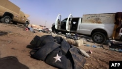 An abandoned jacket and boots belonging to the Iraqi security forces litter the ground at the Kukjali Iraqi Army checkpoint some 10 kilometers of east of the northern city of Mosul, on June 11.