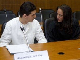 Arid Uka (left) talks with his lawyer Michaela Roth as he arrives for the start of his trial in Frankfurt.