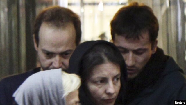 Jailed German journalists Marcus Hellwig and Jens Koch (back, left to right) were allowed to meet with relatives in Tabriz on December 28.