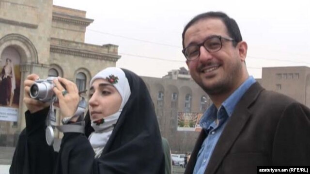 Armenia -- An Iranian couple takes pictures in Yerevan's Republic Square, 21Mar2011.