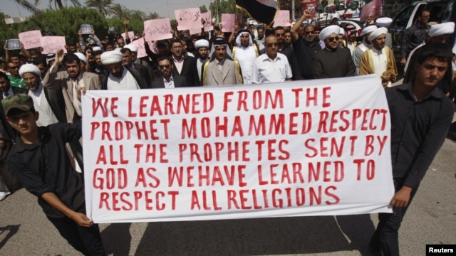Iraqis hold a banner and shout slogans during a protest against a film seen as insulting the Prophet Muhammad in Basra.