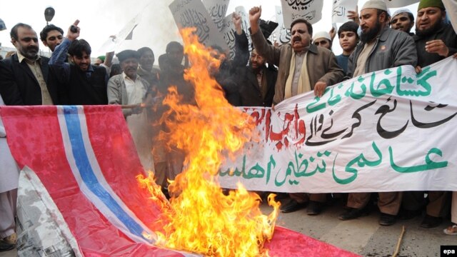 Supporters of an Islamic party in Pakistan in 2010 burn a Norwegian flag during a protest in Lahore against the republication of the controversial Muhammad caricatures.