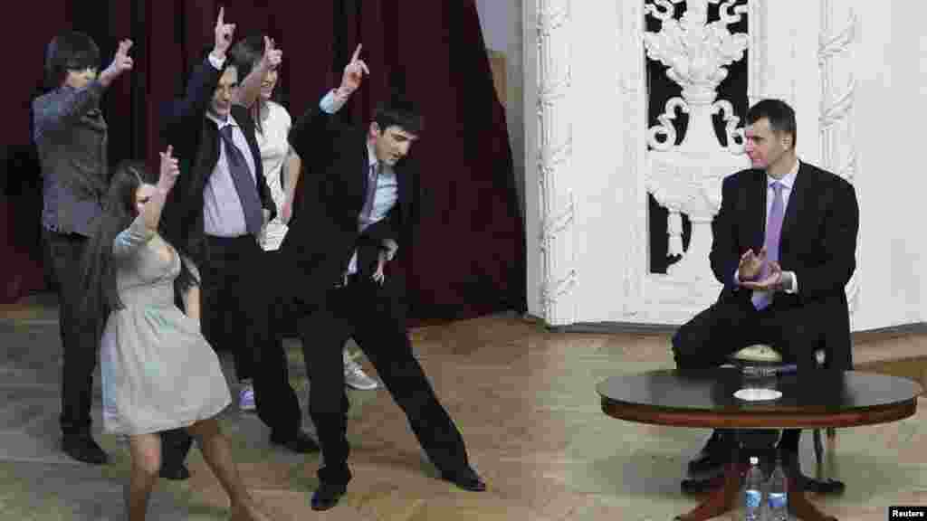 Russian billionaire and presidential candidate Mikhail Prokhorov (right) watches a performance staged by students from the Financial University under the Government of the Russian Federation in Moscow on February 14. (Reuters/Denis Sinyakov)