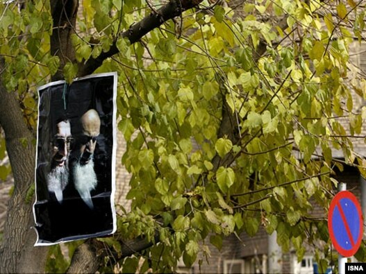 A picture of Ayatollah Ruhollah Khomeini and Iran's supreme leader, Ayatollah Ali Khamenei, hangs on a tree during a pro-government demonstration in Tehran on December 14.