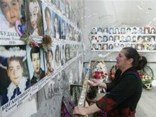 Russia --  A woman cries near children's pictures in the destroyed school sport hall in Beslan, 30May2007