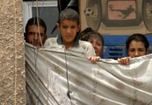 Iraq – Security – A family look from the balcony of their apartment on the scene of a suicide bombing near the Green Zone, Baghdad, 11Jul2006