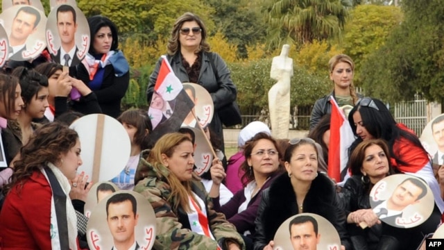 An official handout photo showing Syrian supporters of President Bashar al-Assad protesting in Damascus on November 14.