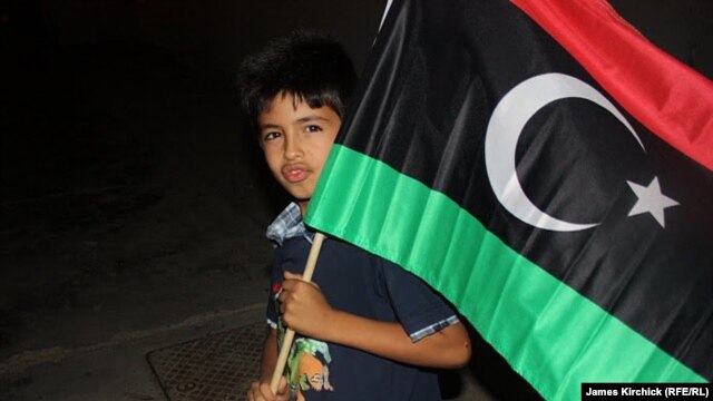 A boy carries the free Libyan flag in Zawahiya on August 24.