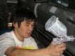 A 15-year-old works at a body shop in Almaty, making repairs to damaged cars (RFE/RL)
