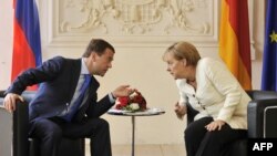Russian President Dmitry Medvedev (left) and German Chancellor Angela Merkel hold talks near Munich.